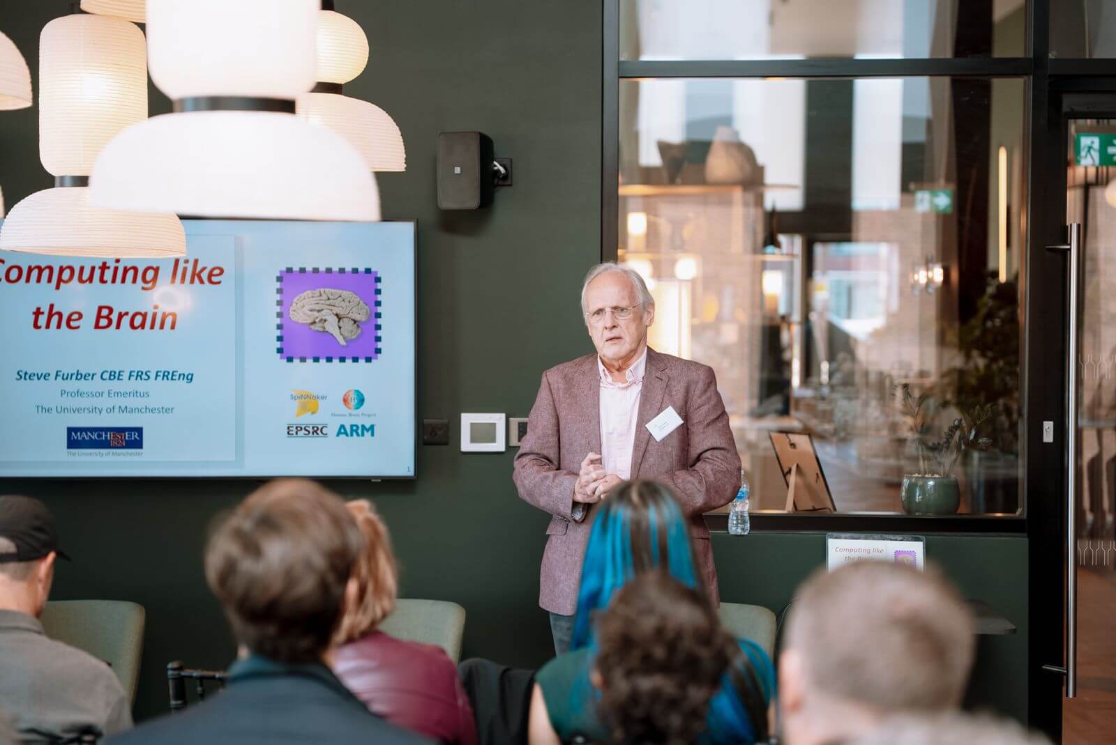 A speaker addressing the summit on computing like the brain