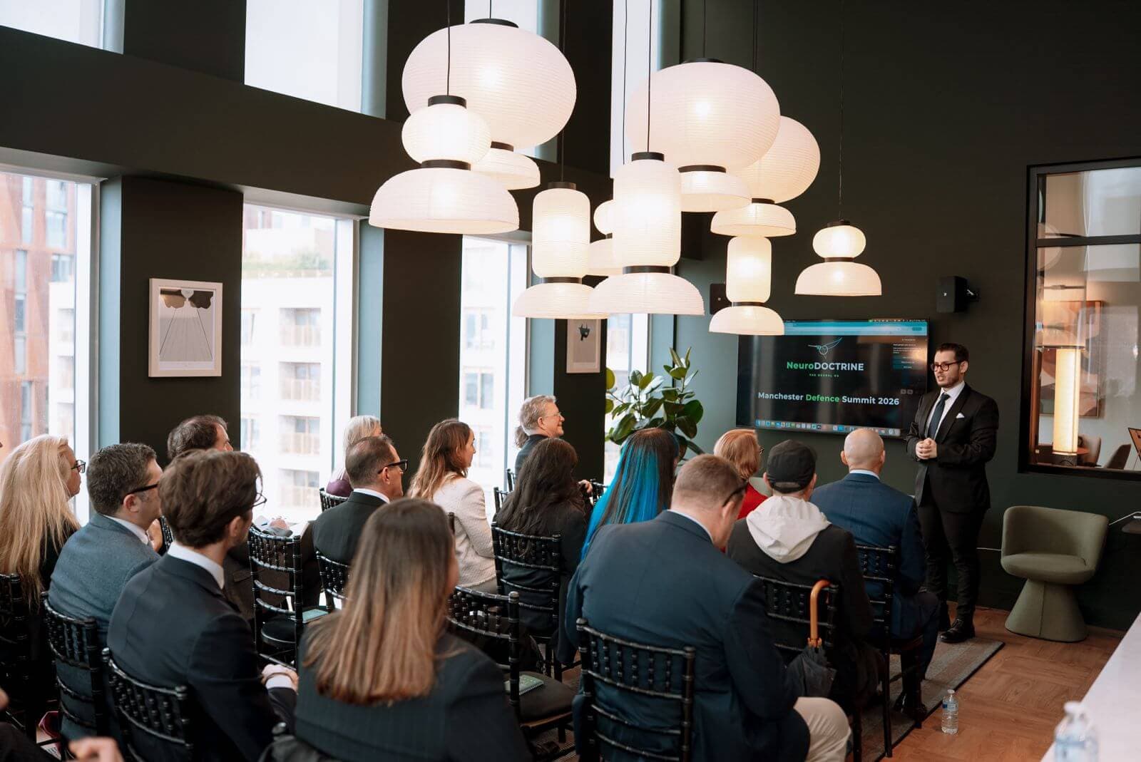 A speaker addressing guests at the NeuroDoctrine Manchester Defence Summit
